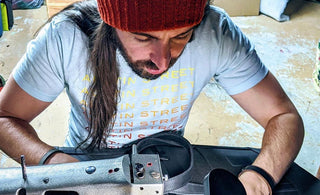 James McLaughlin artist in portland maine creating leather bag with sewing machine