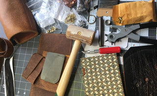 Work bench with leather, mallet, and other leather working tools